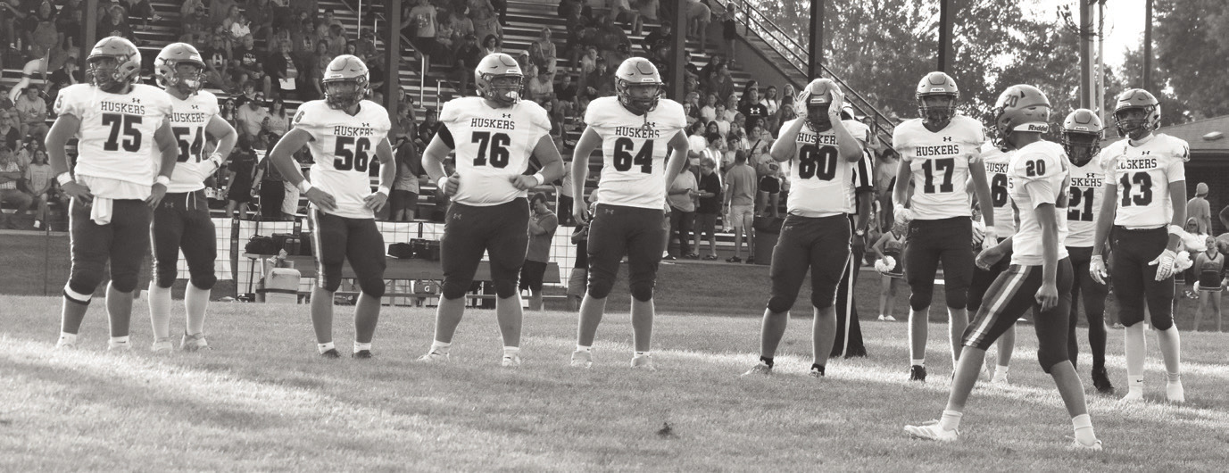 Husker football opener players battling at the line of scrimmage during high school game